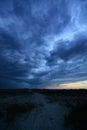 Dark storm clouds above sand road in steppe Royalty Free Stock Photo