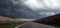 Dark storm clouds over the highway. Royalty Free Stock Photo