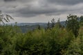 Dark storm clouds over the mixed forest trees Royalty Free Stock Photo