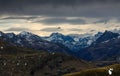 Dark storm clouds over snow spotted mountains. Allgau, Alps, Germany.