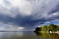 Dark storm clouds before rain above the lake Royalty Free Stock Photo