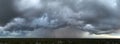 Dark stormy clouds forming on gloomy sky before heavy rainfall over suburban town area