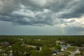 Dark stormy clouds forming on gloomy sky before heavy rainfall over suburban town area