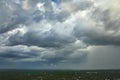 Dark stormy clouds forming on gloomy sky before heavy rainfall over suburban town area