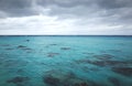 Dark stormy clouds over the crystal blue sea Royalty Free Stock Photo