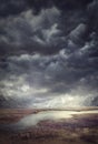 Dark  stormy clouds in valley  with pond, landcape Royalty Free Stock Photo