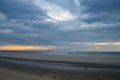 A dark stormy cumulonimbus cloudy coastal ocean sunrise seascape. Huay Yang,Thailand