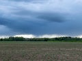 Dark stormy skies on a contrasting green field background Royalty Free Stock Photo