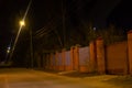 Dark street, a lantern on an old brick wall, a large moon, smoke, smog Royalty Free Stock Photo