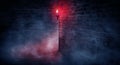 A dark street, a red lantern, a brick wall, smoke, a corner of the building, a lantern shining. Royalty Free Stock Photo