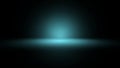 Dark studio background with a soft glowing blue spotlight effect Royalty Free Stock Photo