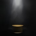 Dark Studio Room with a Gold Pedestal on a Glossy Surface, Spotlight and Light Smoke or Fog. Minimalist Black Product Showcase.