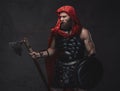 Dark studio room and rome fighter with axe and shield Royalty Free Stock Photo