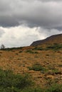 Dark summer clouds loom over an expanse of the stark rocky beauty of the Tablelands ophiolite Gros Morne National Park Canada Royalty Free Stock Photo