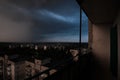 Dark summer storm clouds over residential city buildings and rooftops Royalty Free Stock Photo