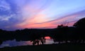 Dark sunset with crimson clouds. Twilight over lake. Dusk above river Royalty Free Stock Photo