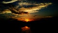 Dark dramatic sunset reflection on river Royalty Free Stock Photo