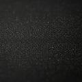 A dark surface dotted with numerous tiny, white specks creates a shimmering effect. Royalty Free Stock Photo
