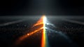 A dark surface features a central beam of light, transitioning from bright white to warm orange hues Royalty Free Stock Photo