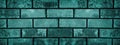 Dark teal rough brick wall closeup texture. Shabby turquoise color block masonry. Retro grunge brickwork background