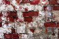 Texture of an old wall of an ancient building with a ruined plaster layer and cracked red bricks, abstract background Royalty Free Stock Photo
