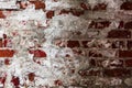 Texture of an old wall of an ancient building with a ruined plaster layer and cracked red bricks, abstract background Royalty Free Stock Photo