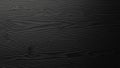 Dark textured black wood grain background with subtle light and shadow Royalty Free Stock Photo