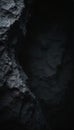 Dark textured cave wall surface shows rough uneven stone formations. Deep shadows fill cavern interior, creating abstract copy Royalty Free Stock Photo