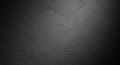 Dark textured concrete wall surface with dramatic lighting casting shadows and highlighting rough plaster details Royalty Free Stock Photo