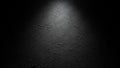 Dark textured plaster wall with a single spotlight creating dramatic shadows Royalty Free Stock Photo