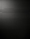 Textured black surface with perforated pattern under soft lighting effect Royalty Free Stock Photo