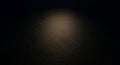 A dark, textured surface is partially illuminated by a soft, diffused light from above. The texture Royalty Free Stock Photo