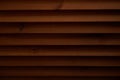 Dark textured wooden background with holes. The surface of the brown texture of wooden blinds Royalty Free Stock Photo