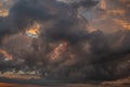 a dark thundercloud on the background of sunset