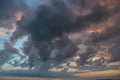 a dark thundercloud on the background of sunset