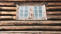 Dark timbered wooden wall with window. Old building. Royalty Free Stock Photo