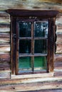 Dark timbered wooden wall with window. Old building. Royalty Free Stock Photo