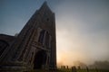 Dark Tower and Graveyard in Misty Sunrise