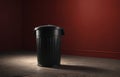 Dark trash can on a plain advertising background. Concept of ecology saving, recycling Royalty Free Stock Photo