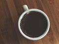 Dark turkish coffee in a white cup on the wooden table. Royalty Free Stock Photo