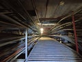 Dark underground tunnel with high-voltage wires laid in iron trays