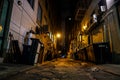 Dark urban alleyway with dim lights in the city Royalty Free Stock Photo