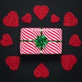 The dark valentine card with red hearts and holiday gift with green ribbon. Saint Valentine`s Day or the Feast of Saint Valentine