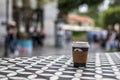 Dark vending coffee in disposable kraft paper cup and plastic lid on table at street cafe Royalty Free Stock Photo