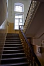 Dark vintage staircase interior in old building, stair with forged railing Royalty Free Stock Photo