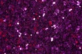 Dark violet glitter confetti on shiny background. Purple glitter texture.