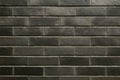 A dark wall of bricks. Background, texture of the wall of the building. Royalty Free Stock Photo