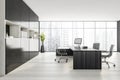 Black and white consulting room with furniture and panoramic windows