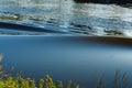 Dark water wave in the golden river leie at belgium kortrijk Royalty Free Stock Photo