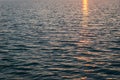 Dark water waves texture. Reflection of sunlight on the water. Natural background